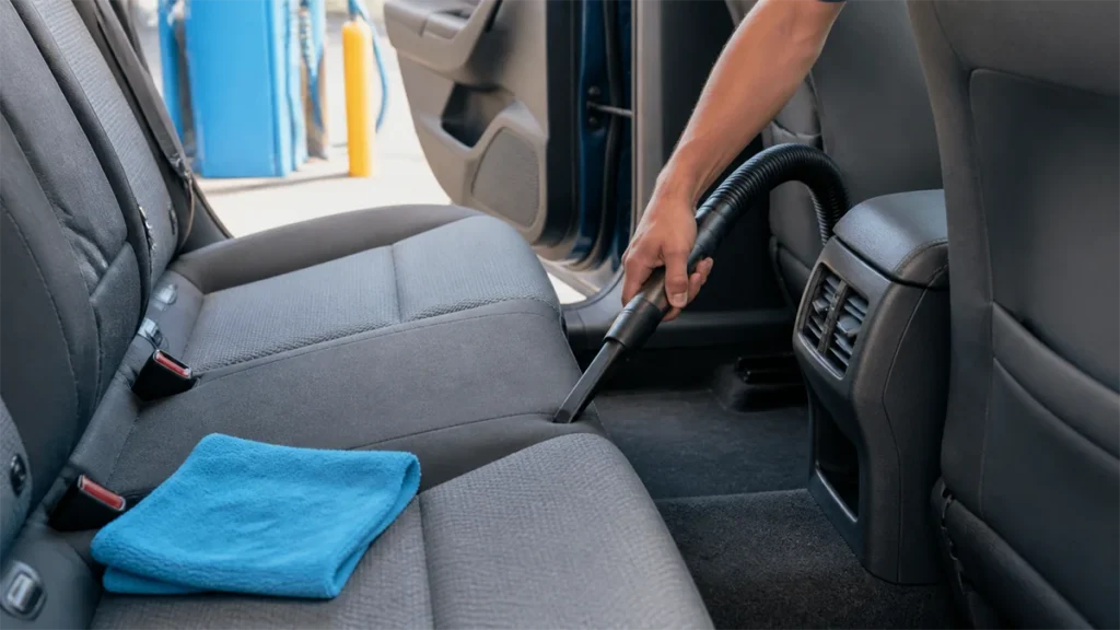 vacuuming out car at car wash
